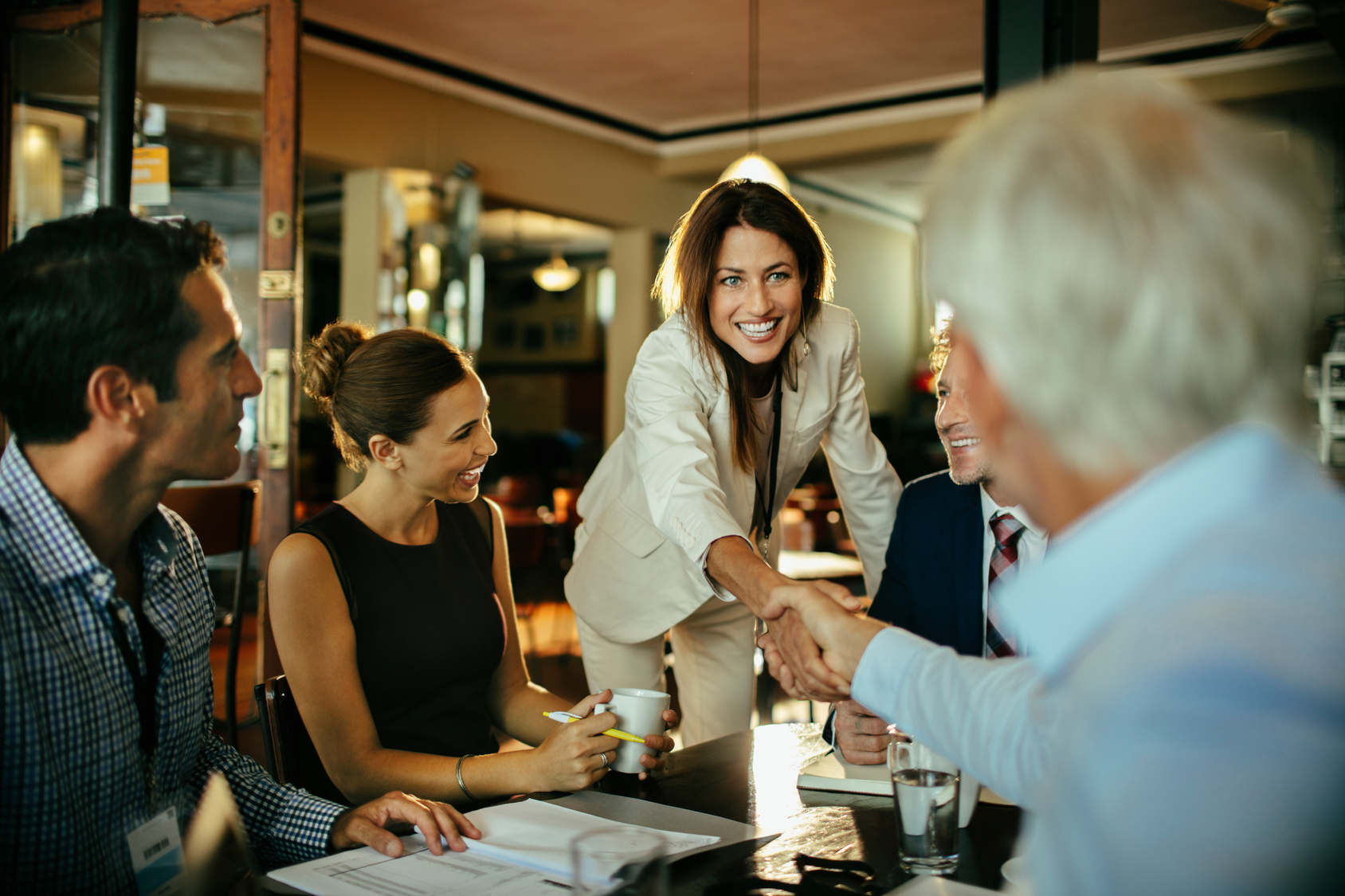 Diverse group of business coworkers having a meeting in a cafe or bar